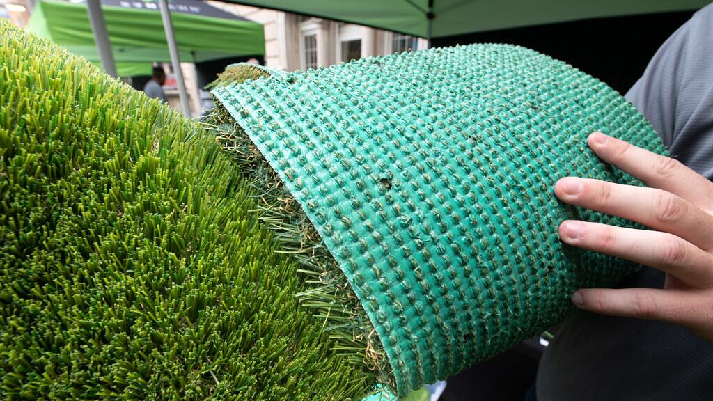 Synthetic turf roll showing its backing